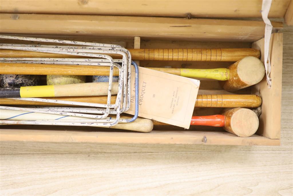 An early 20th century pine cased croquet set